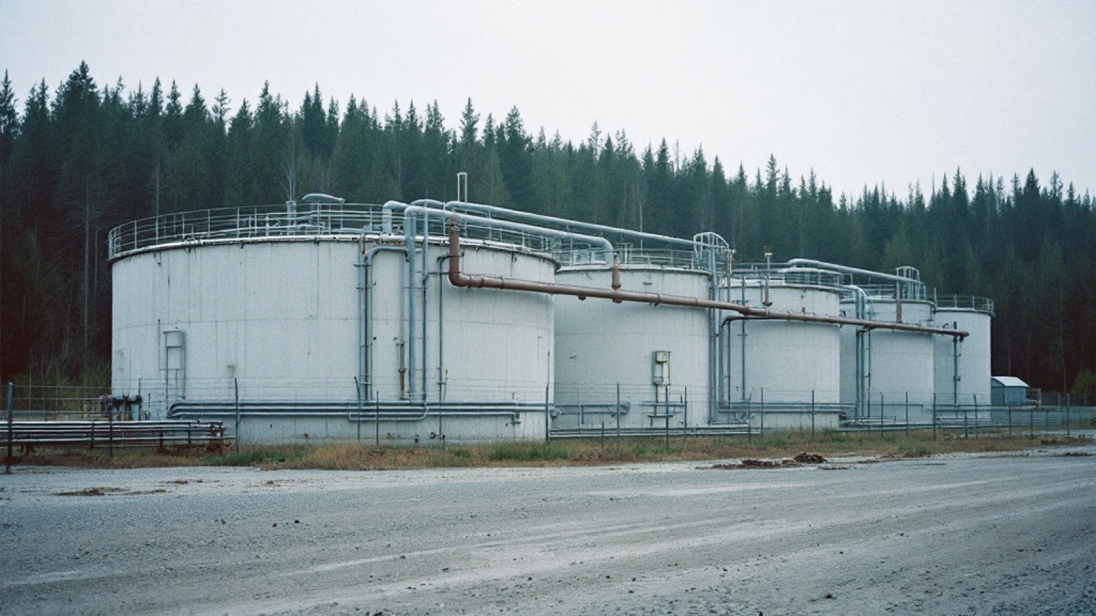 A tank battery on a fenced lease pad